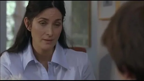 Carrie Anne Moss is fucked by guy who got tempted by her boobs
